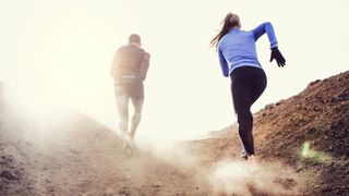 male and female running uphill