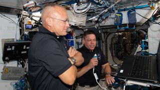 NASA astronauts Doug Hurley (foreground) and Bob Behnken, who flew to the International Space Station for SpaceX's Demo-2 mission, brief mission controllers about their experience in SpaceX's new Crew Dragon spacecraft, on June 1, 2020. 