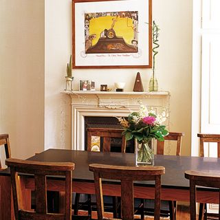 dinning area with wooden table chair and flower vase