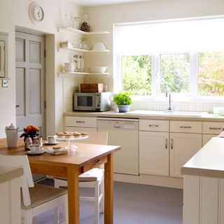 kitchen with corner shelving and table and chair