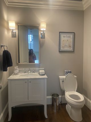 A dated powder room with a white vanity