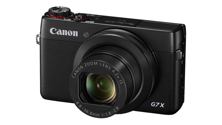Canon compact camera against a white background