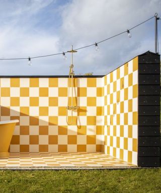 Outdoor shower with yellow and white chequerboard tiles