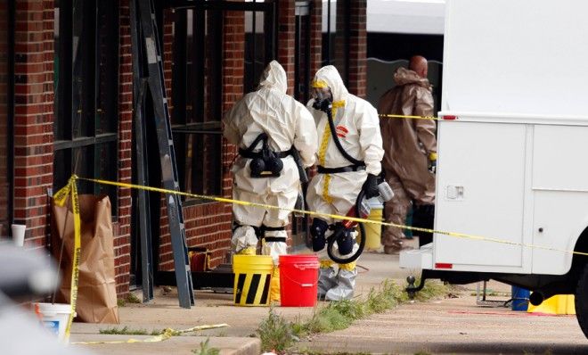 Federal authorities in hazmat suits