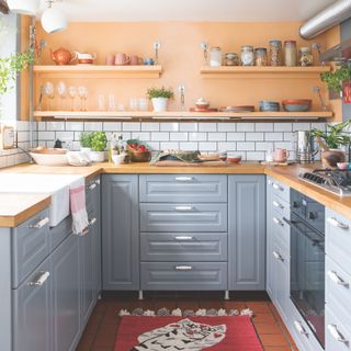 grey kitchen with peach walls