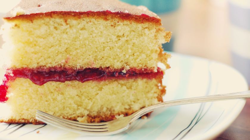 Slice of Victoria sponge cake on plate with fork