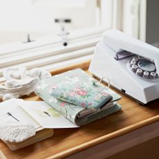 Mobile phone on desk with decorative floral cover