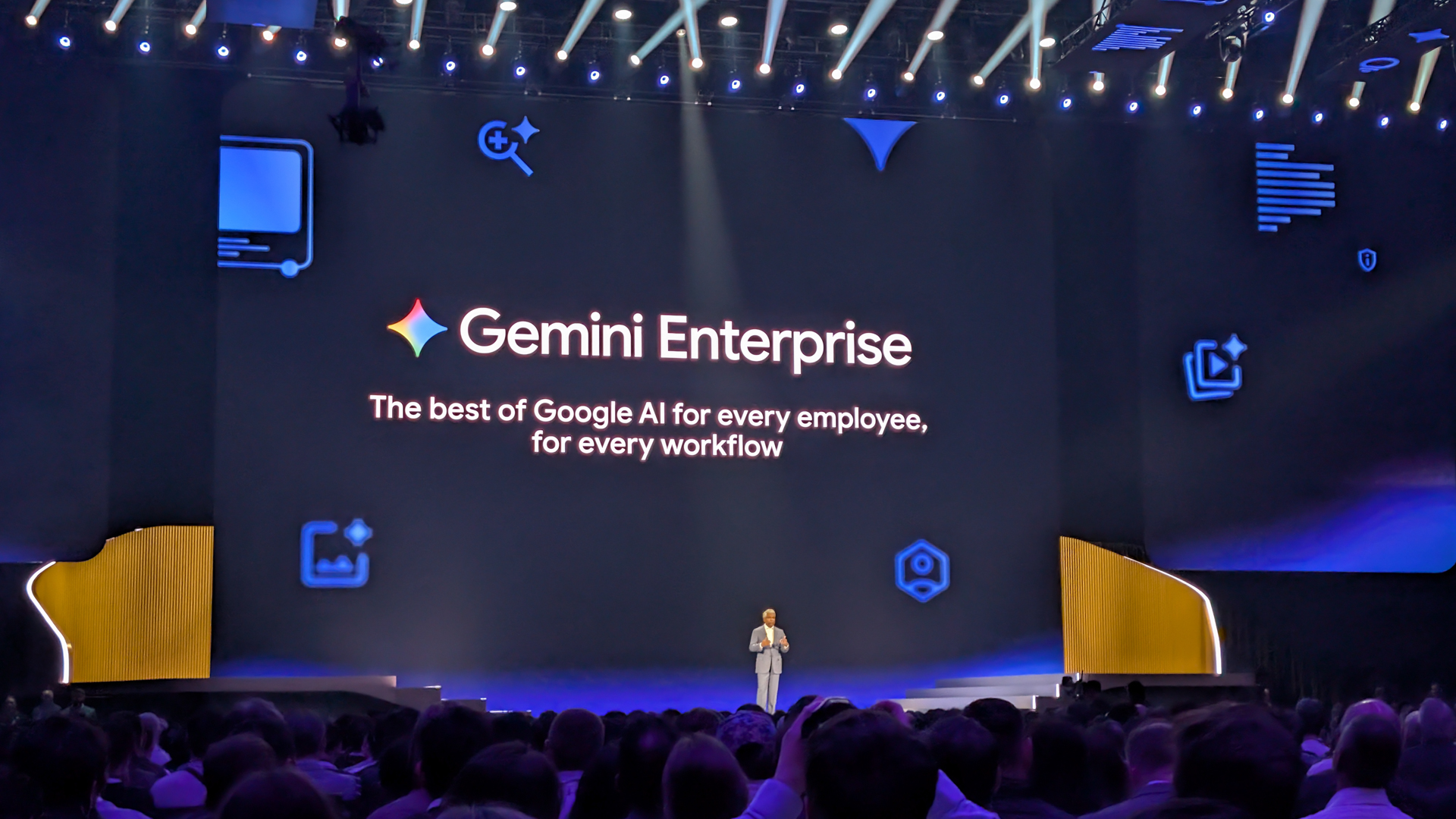 Thomas Kurian, CEO at Google Cloud, speaking onstage at the Google Cloud Next 2026 opening keynote. Behind him, info on Gemini Enterprise is shown onscreen.
