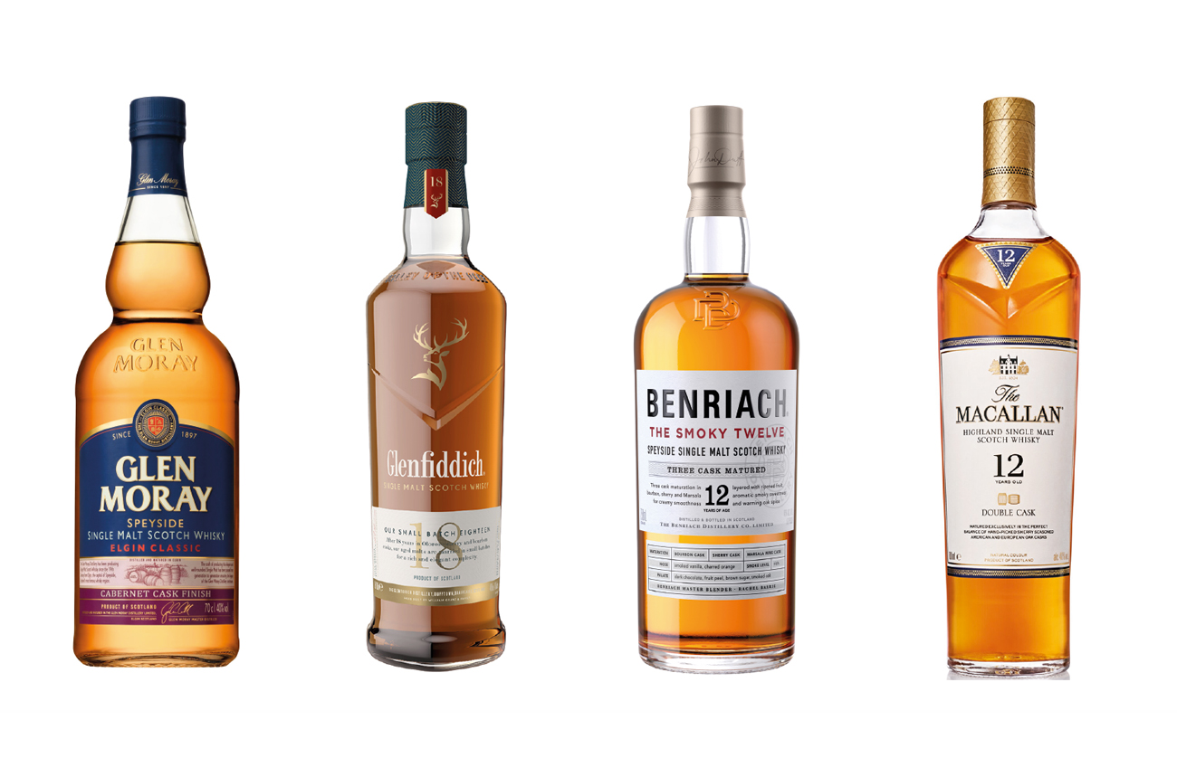 Four bottles of whisky against a white background