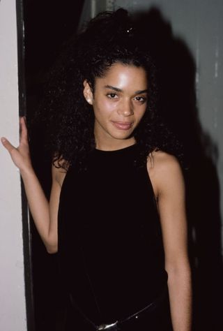 Lisa Bonet wearing a black sleeveless top, her right hand resting on a doorframe, May 1986.