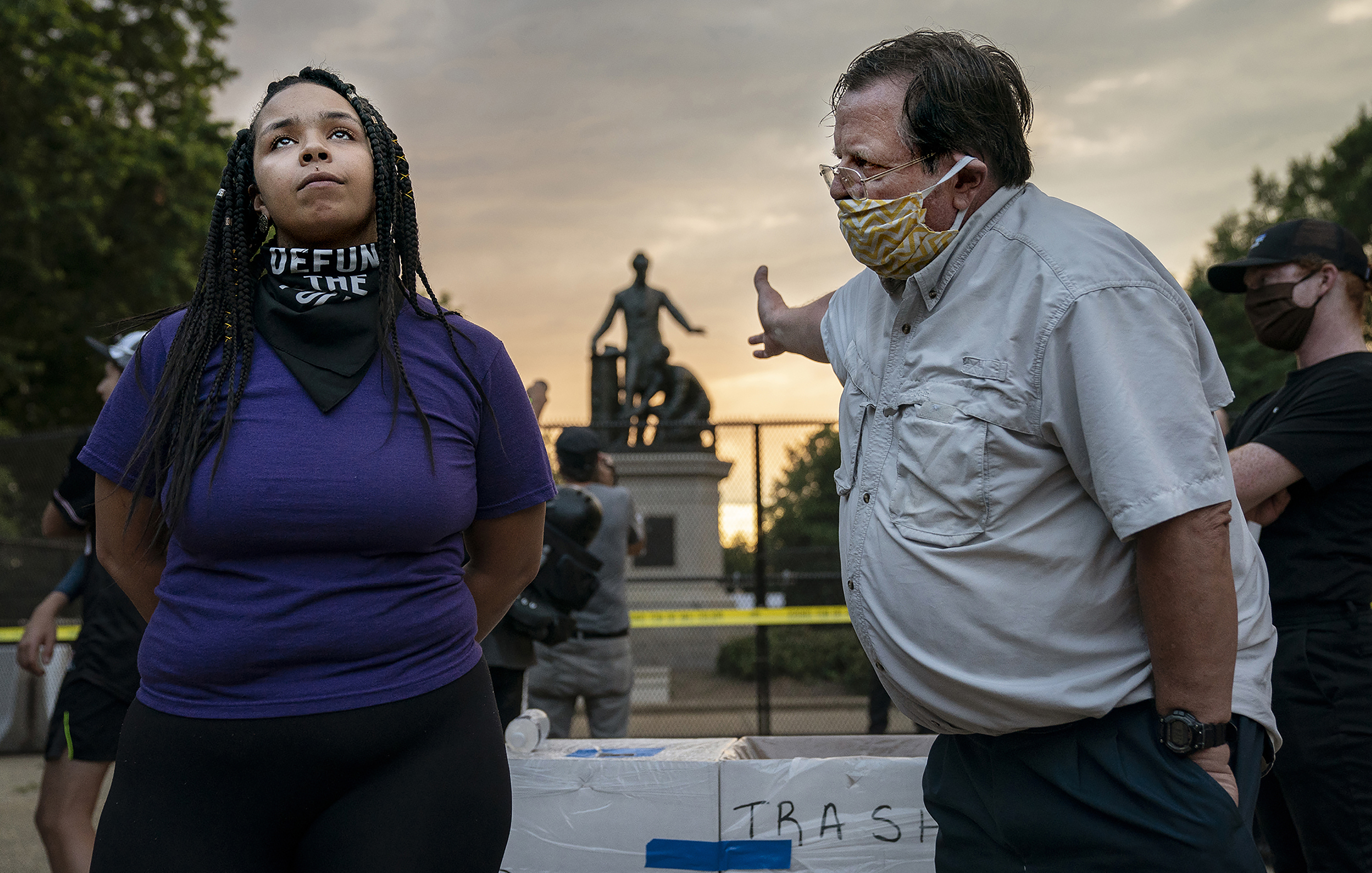 A confrontation between a man and woman in front of a statue