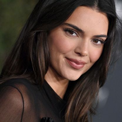 Kendall Jenner smiling at the camera while at the film gala in LA, with a subtle brown eye, and slightly overlined lip