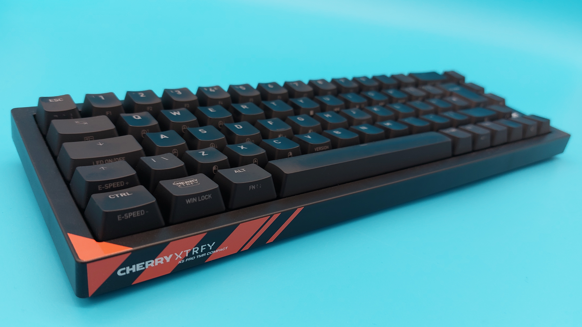 The Cherry K5 Pro TMR Compact gaming keyboard on a blue background.