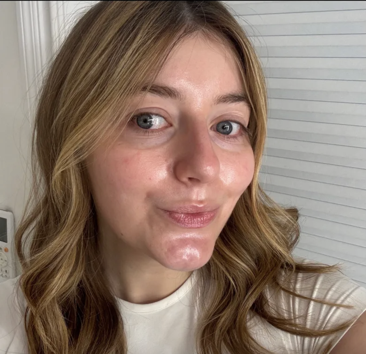 a girl with brown and blonde hair before using the Chantecaille Just Skin Tinted Moisturizer SPF 15.