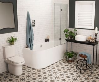 bathroom with showerbath and patterned tiles