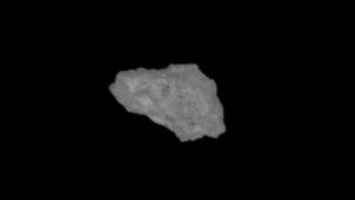 a grey, jagged rock on a black background
