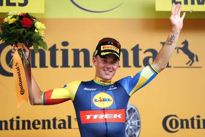 Mads Pedersen waving on the Tour de France podium