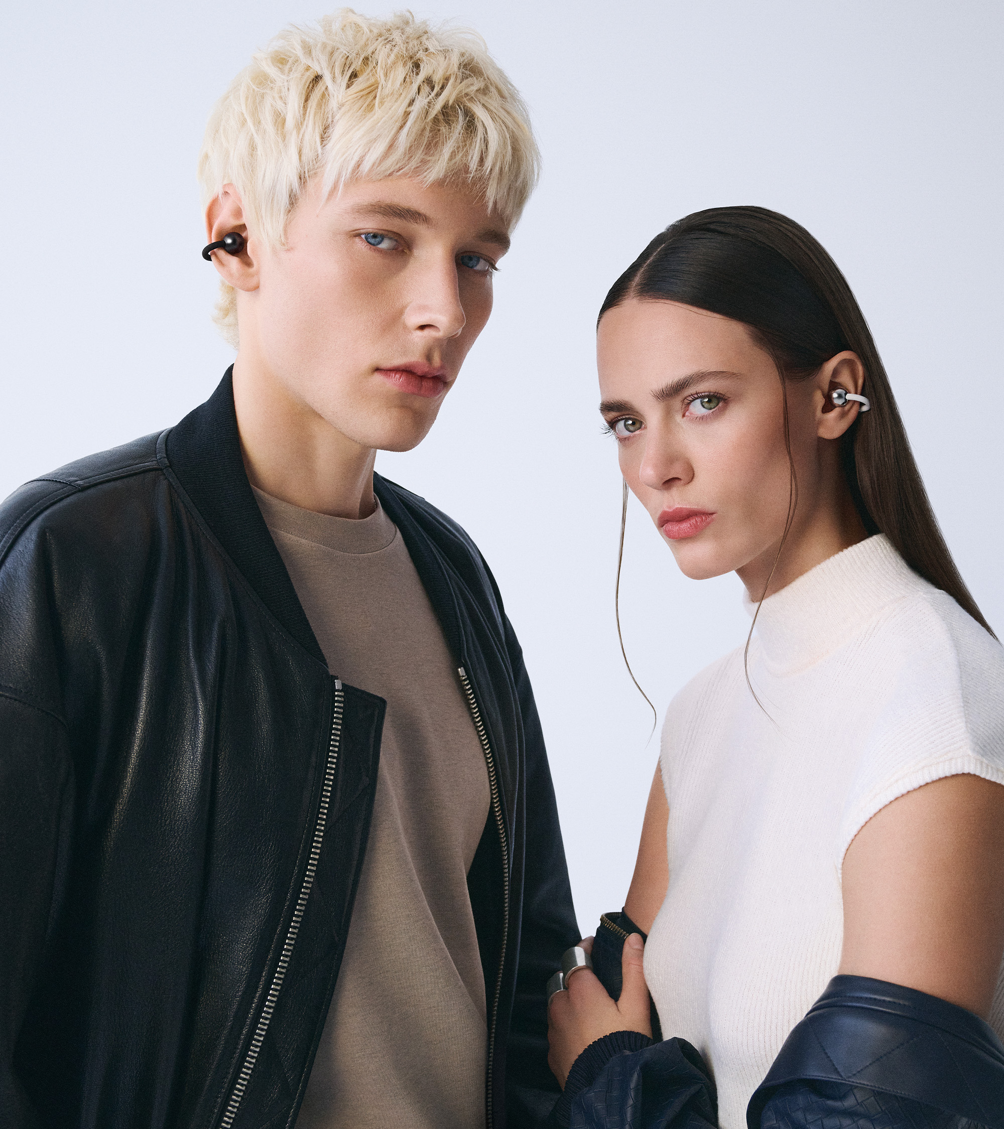 Two models wearing the Huawei FreeClip 2.