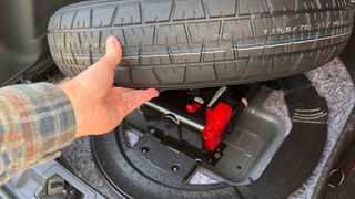 Accessing a car battery under the spare tire