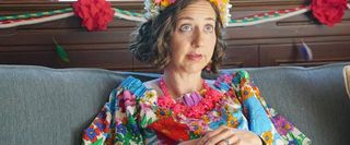 The Last Man On Earth Kristen Schaal dressed colorfully, sitting on a couch
