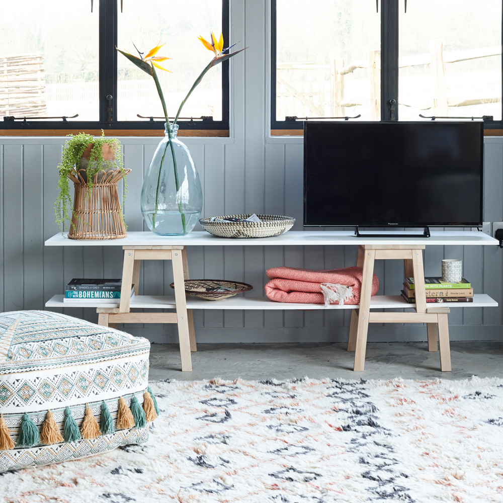 blue wall with tv unit and carpet on floor