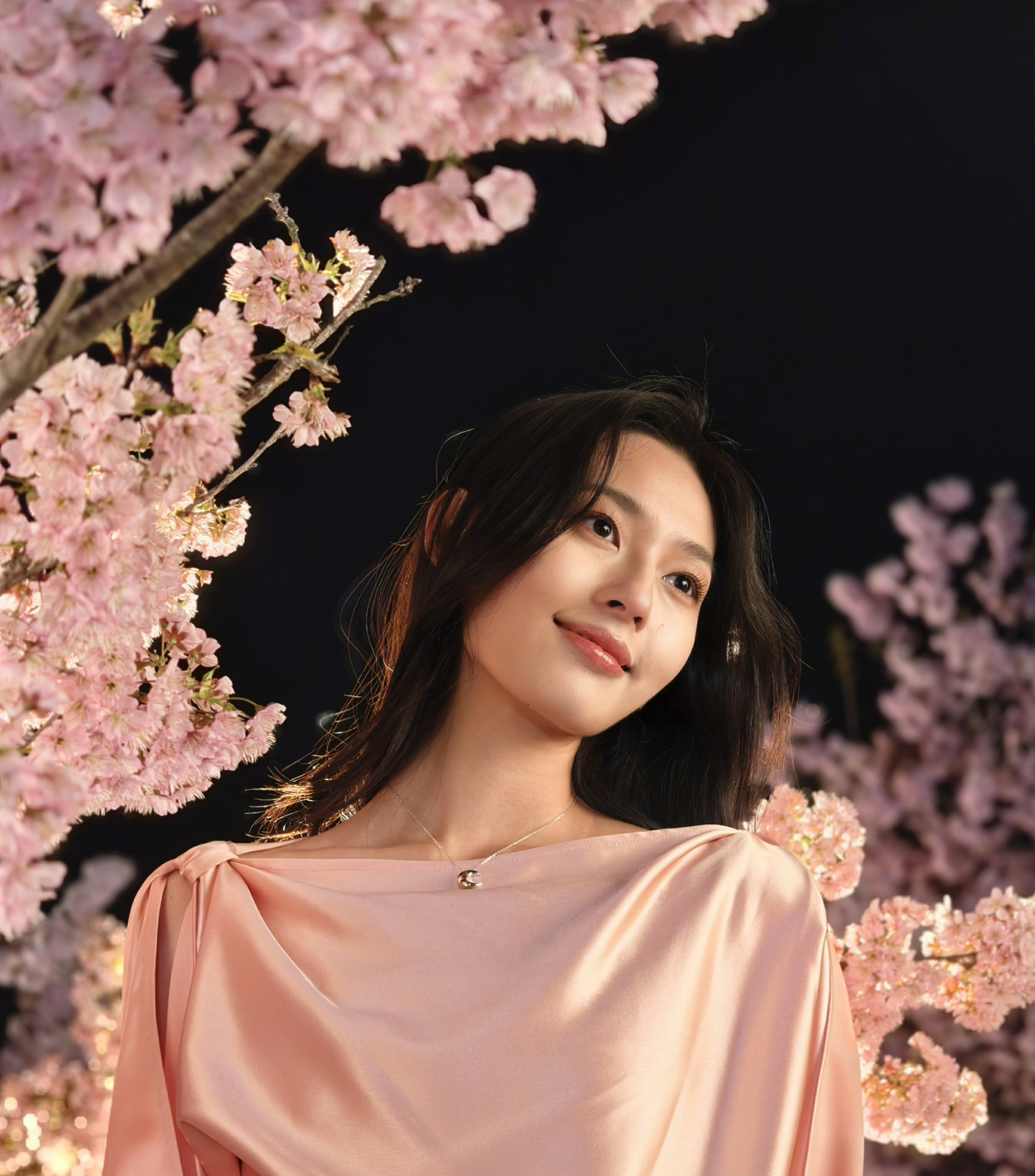 Woman in pink dress surrounded by pink blossom
