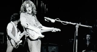 A black-and-white image of Rory Gallagher playing his &#039;61 Strat at the Royal Albert Hall