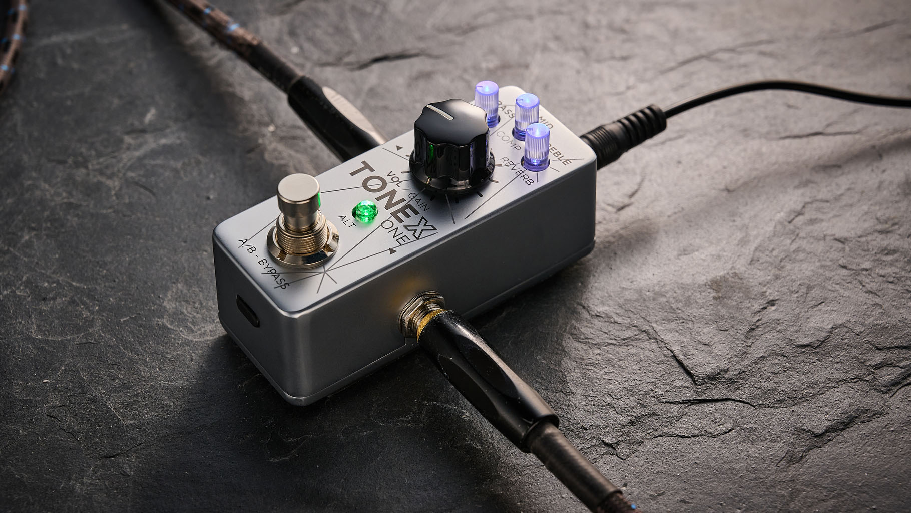 IK Multimedia Tonex One Bass: the mini-pedal offers amp modelling and heaps of tone options and is here photographed against a slate floor.
