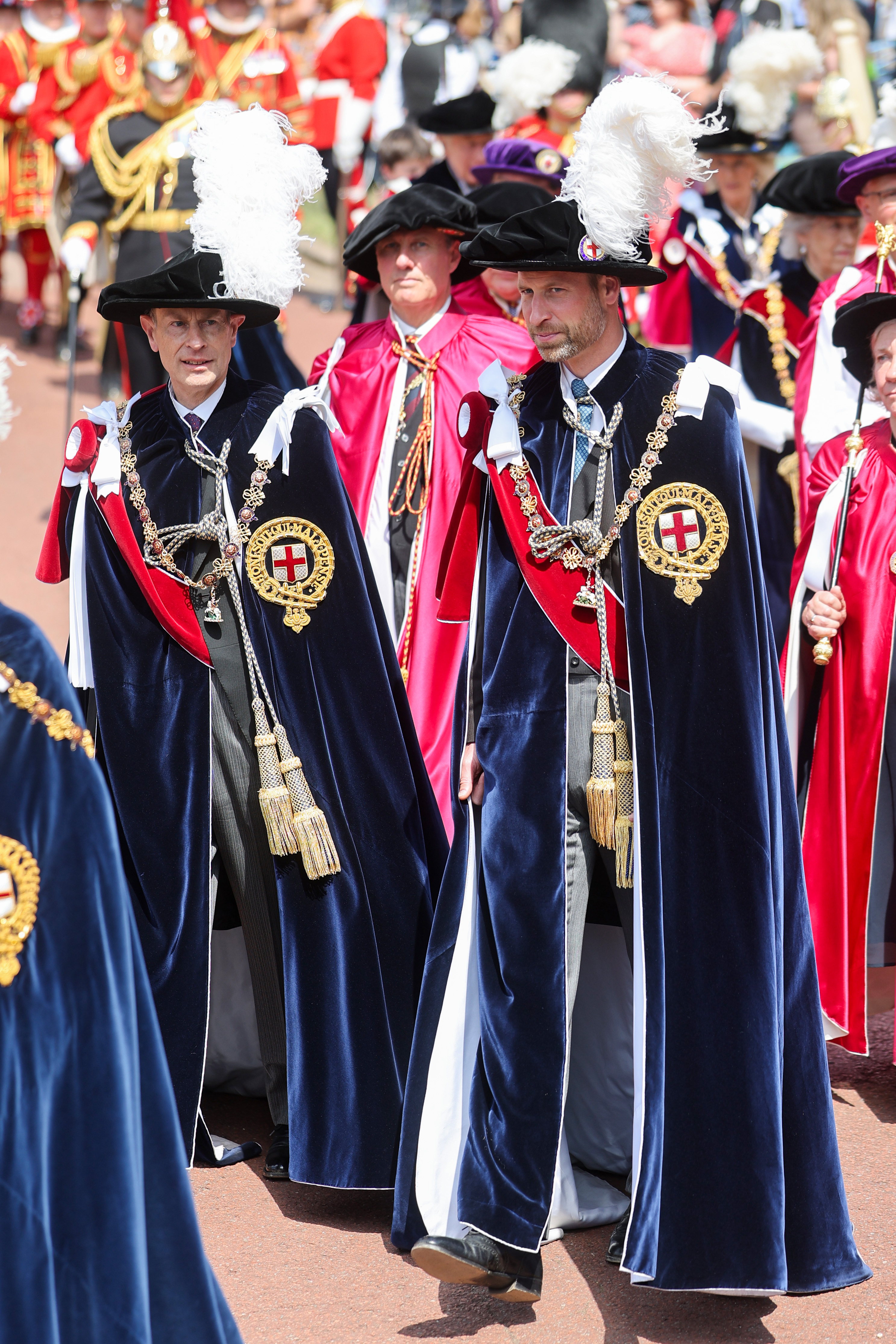 Prince William wearing a velvet cape walking with Prince Edward on Garter Day