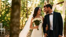Happy newlyweds smiling and walking arm in arm