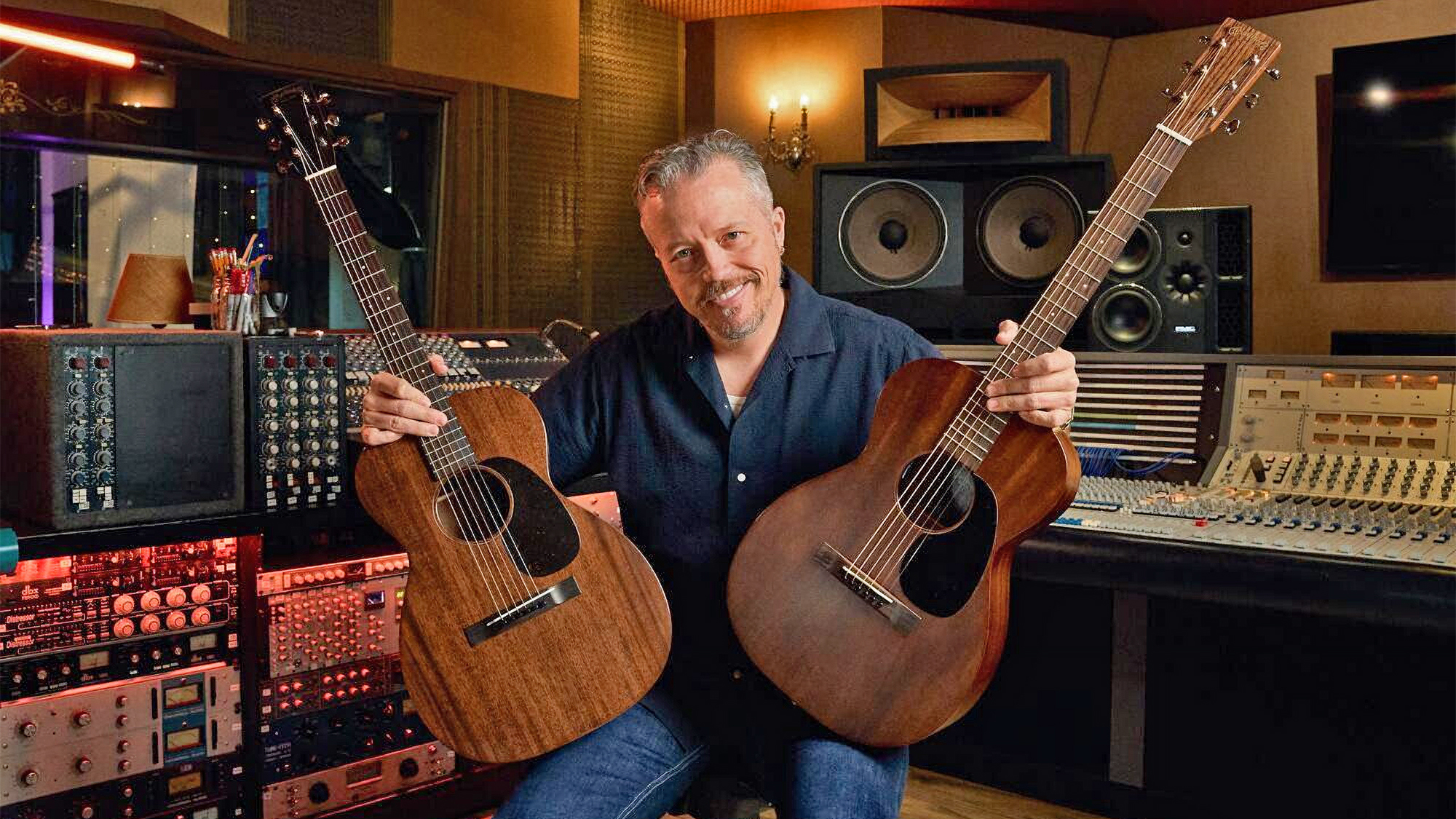 Jason Isbell holds his two Martin signature model acoustic guitars: the 0-17 Jason Isbell (left) and the 0-10E Retro Jason Isbell