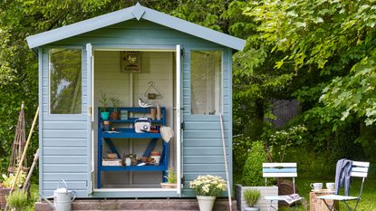 wooden shed with shelf and bbq stand