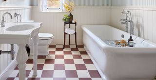 white bathroom with a brown and off-white checkerboard floor to highlight a key bathroom trend 2023