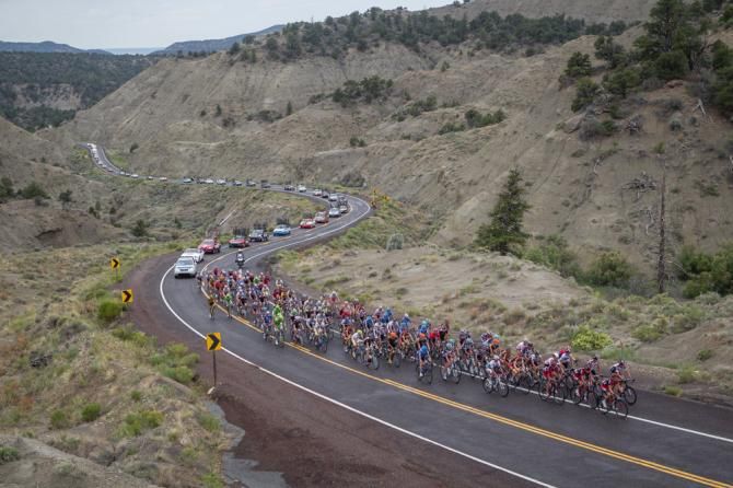 The main field and caravan makes its way up one of today's climbs