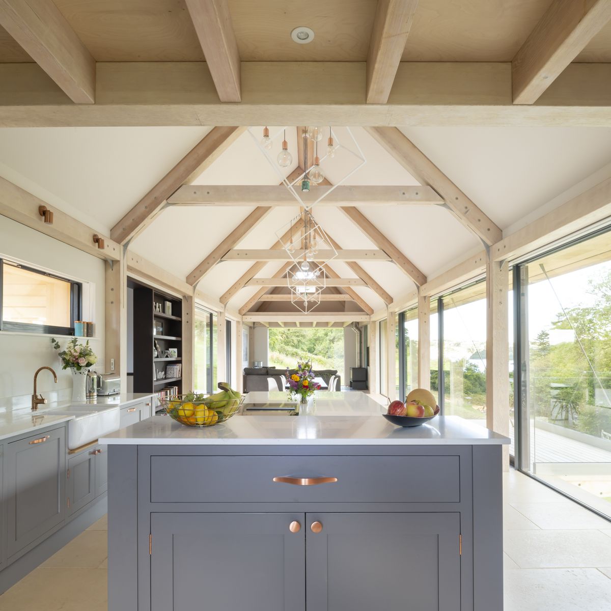 Mezzanines above the snug and the kitchen create more intimate spaces while the vaulted ceiling in the centre showcases the impressive Douglas fir beams.