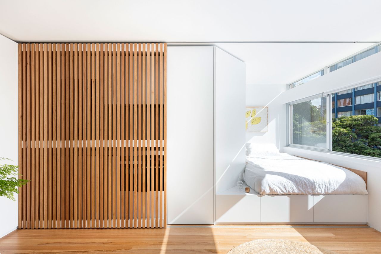 a studio apartment with a sliding screen