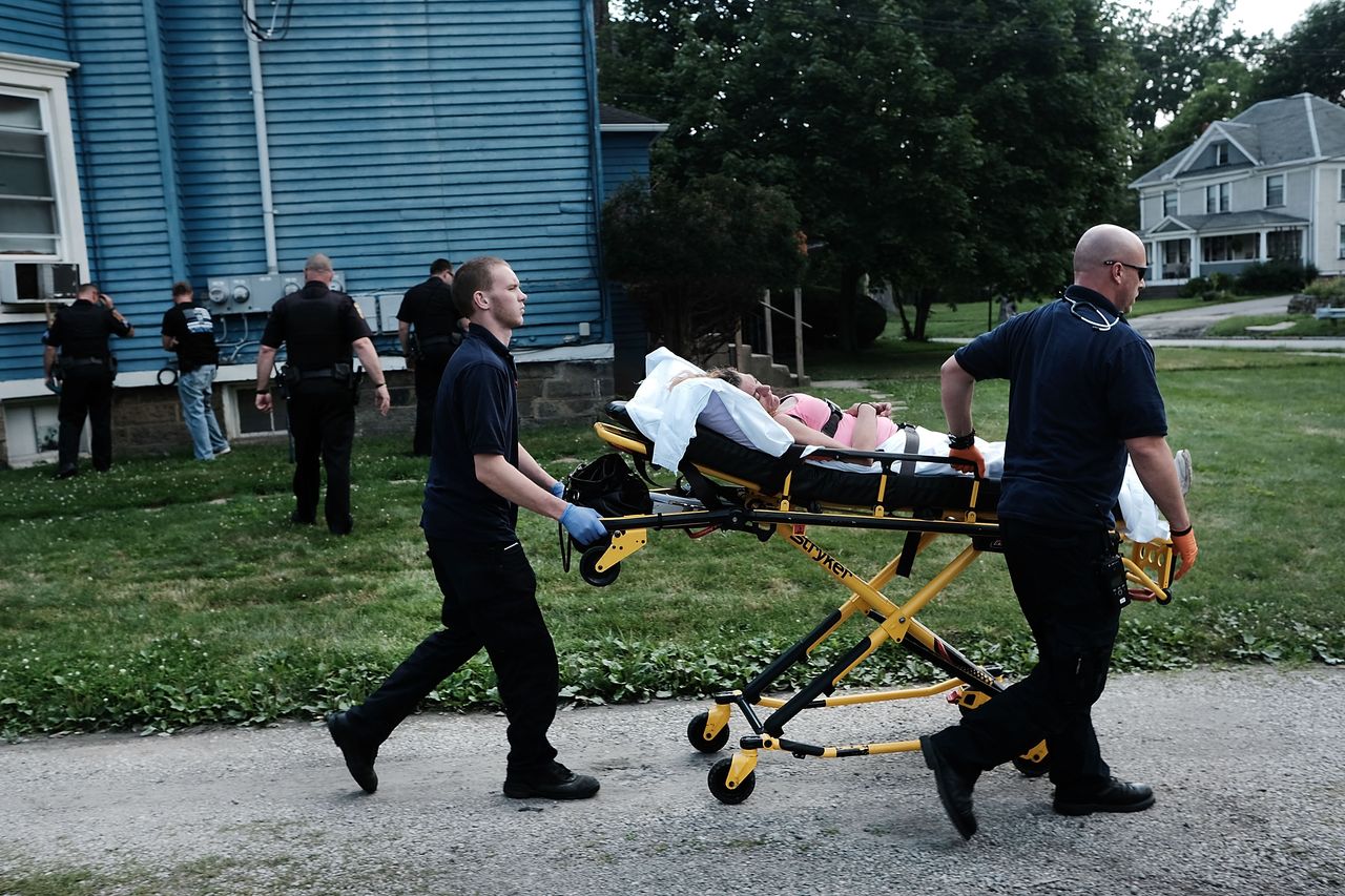 Medical workers take away a woman who has overdosed on heroin in Warren, Ohio.