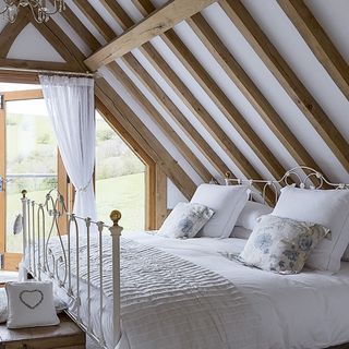 Country bedroom with eaves ceiling and beams