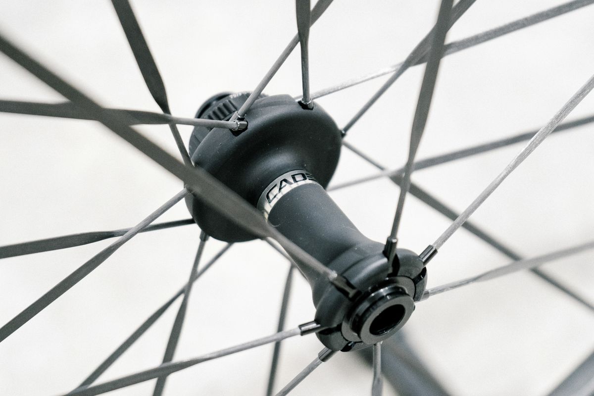 An aero road wheel stands against a white wall
