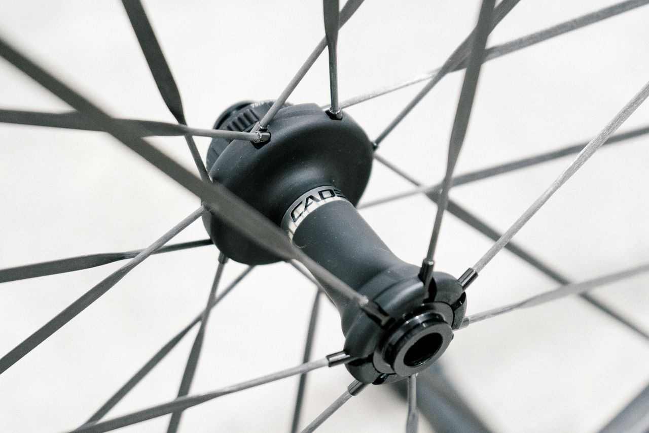 An aero road wheel stands against a white wall