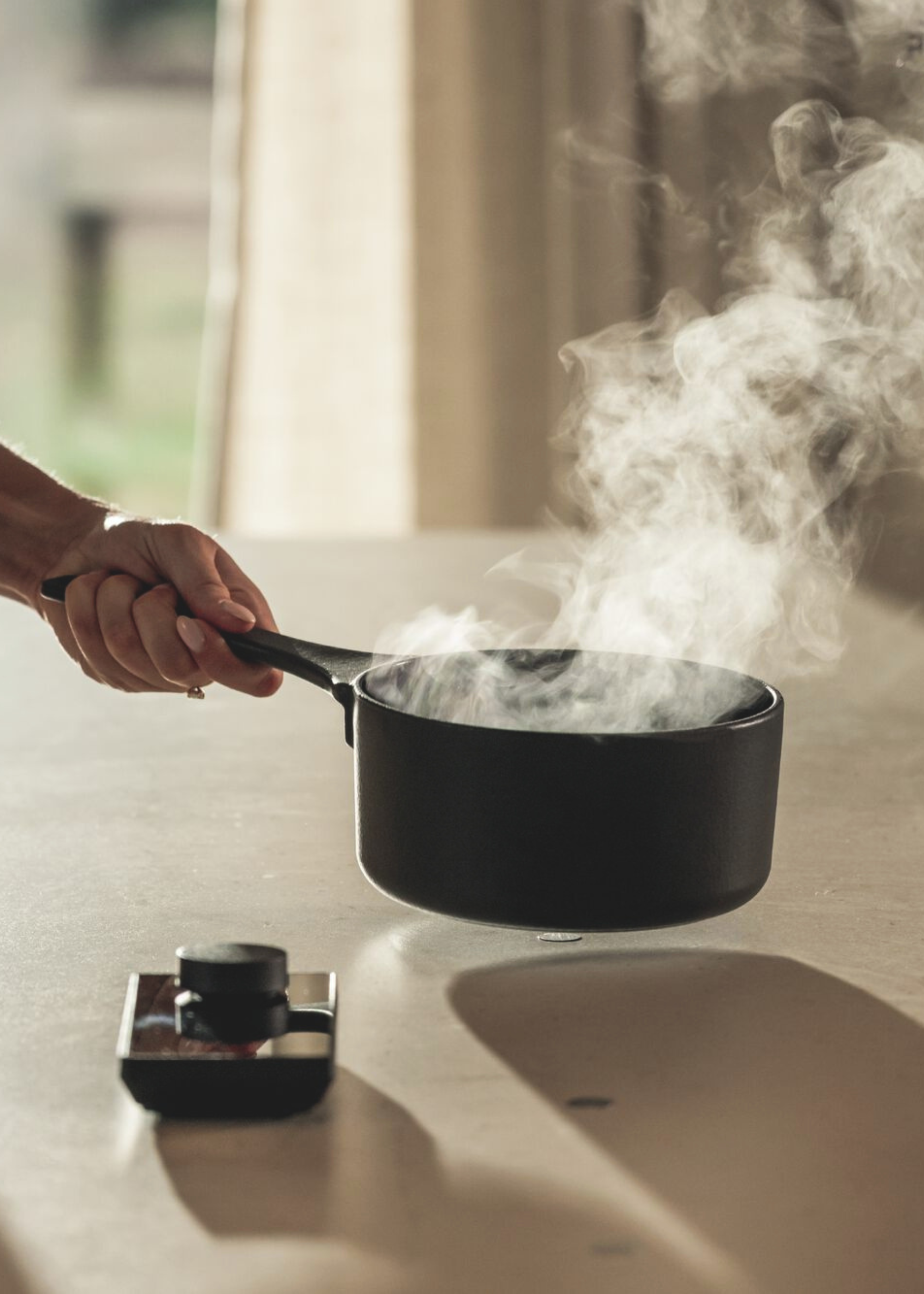novy invisible hob with a steaming pan