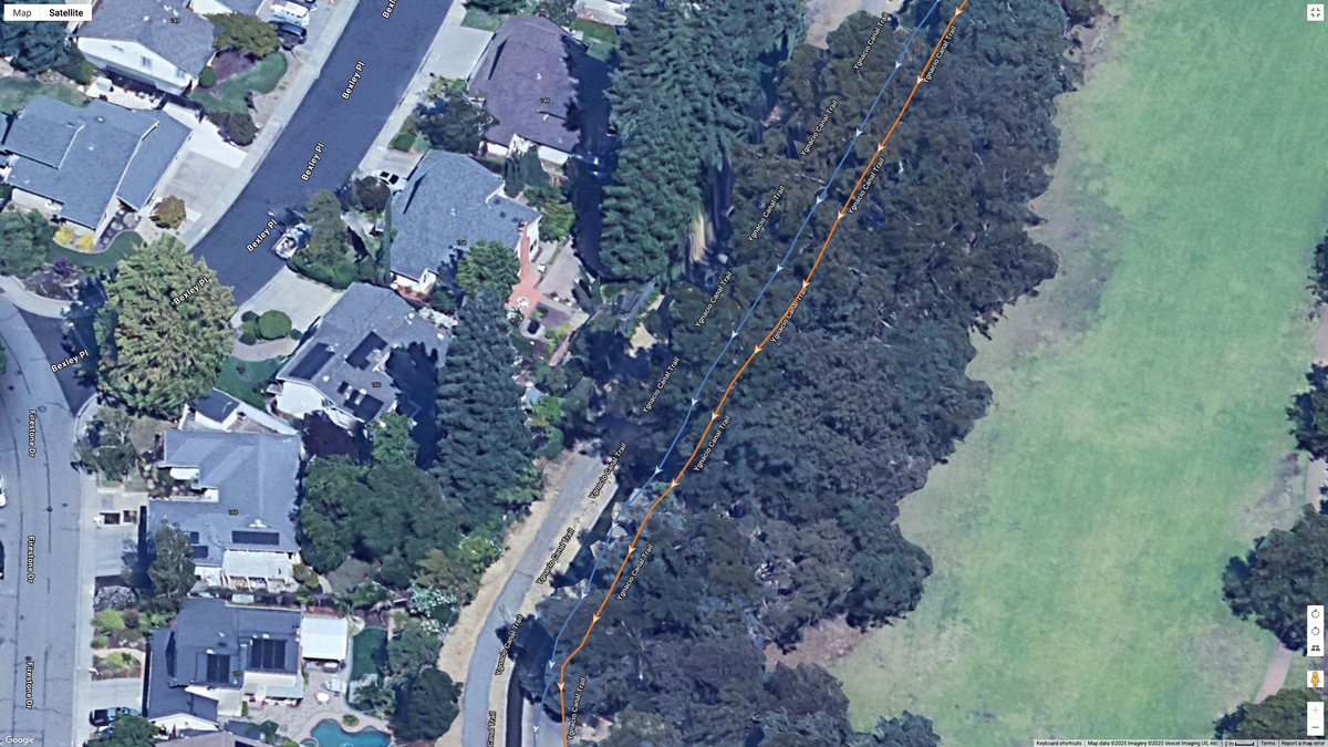 A Google Maps satellite image showing how the COROS PACE 4 (orange line) compares to the Garmin Forerunner 970 (blue line) for dual-frequency GPS accuracy for a suburban route.