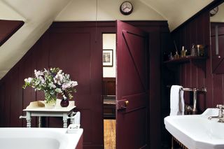 small bathroom painted in a dark purple colour