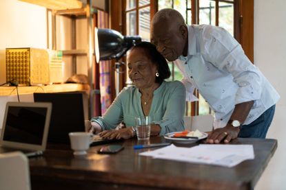 Couple looking at a computer to plan for their retirement