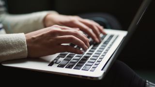 A person typing on keyboard