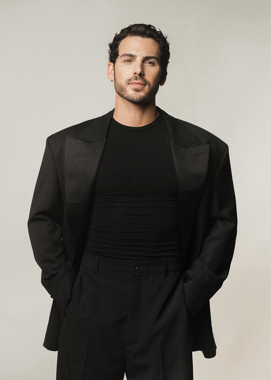 a white man with dark hair in a black suit