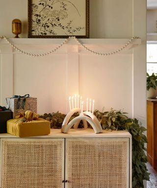 Console table styled with candles foliage and presents