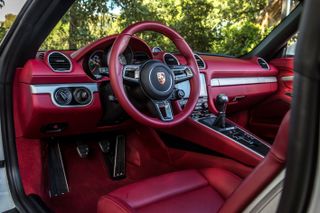 The interiors boast a sports steering wheel .
