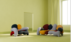 Misha Kahn colourful sofas in a green room