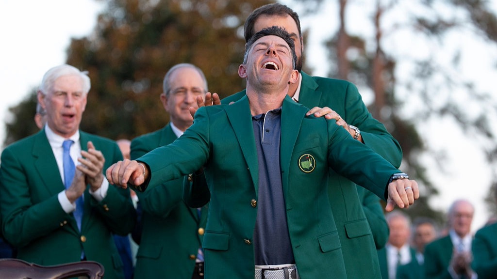Rory McIlroy raises his head up to the sky after being presented with the Green Jacket for winning the Masters 2025
